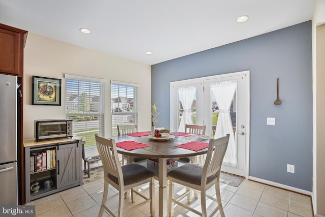 dining space featuring baseboards, light tile patterned flooring, a toaster, and recessed lighting