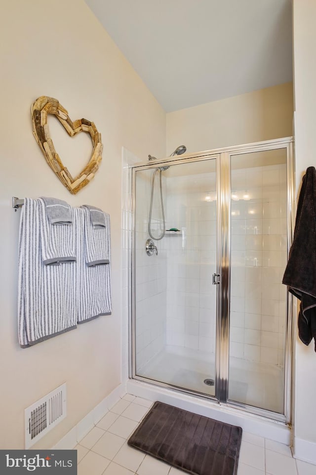 bathroom featuring baseboards, visible vents, tile patterned flooring, and a stall shower