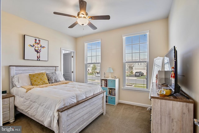 carpeted bedroom with baseboards and ceiling fan