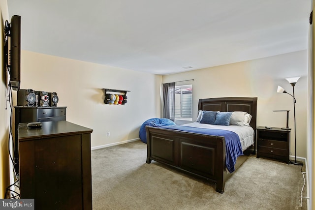 bedroom with visible vents, baseboards, and light carpet