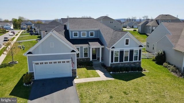 view of front of property featuring board and batten siding, aphalt driveway, stone siding, and a residential view