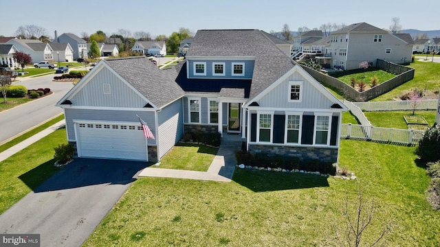 view of front of house with board and batten siding, a residential view, driveway, and stone siding