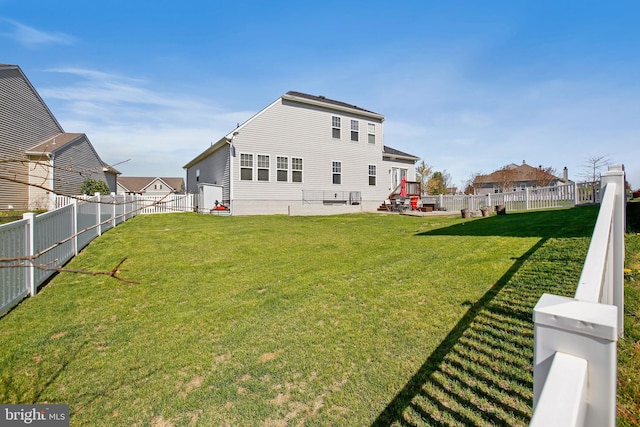 back of property featuring a lawn and a fenced backyard