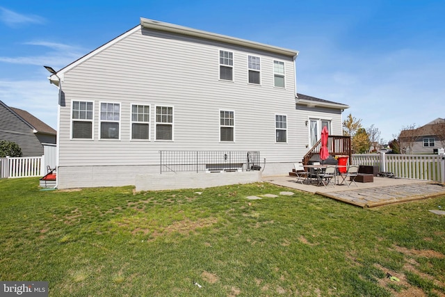 rear view of house featuring a lawn, a patio, and fence