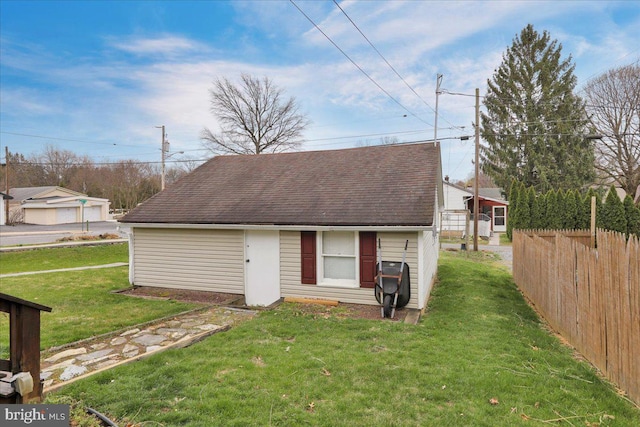 view of outbuilding with fence