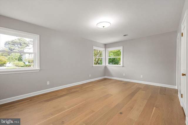 210 N Main St, Berlin, MD 21811 - spare room featuring light wood-type flooring, baseboards, and plenty of natural light
