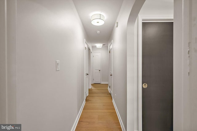 210 N Main St, Berlin, MD 21811 - corridor with baseboards, arched walkways, and light wood finished floors
