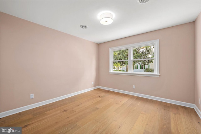 210 N Main St, Berlin, MD 21811 - empty room with baseboards, light wood-style floors, and visible vents