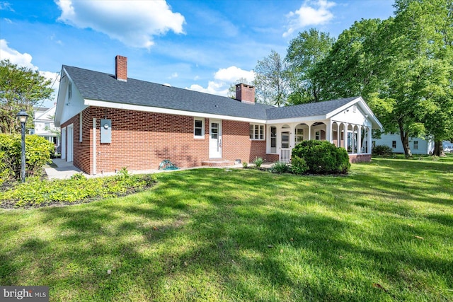 210 N Main St, Berlin, MD 21811 - rear view of property with a lawn, brick siding, a chimney, and roof with shingles