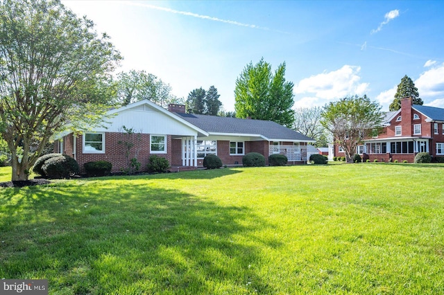 210 N Main St, Berlin, MD 21811 - ranch-style home with brick siding, a chimney, and a front yard