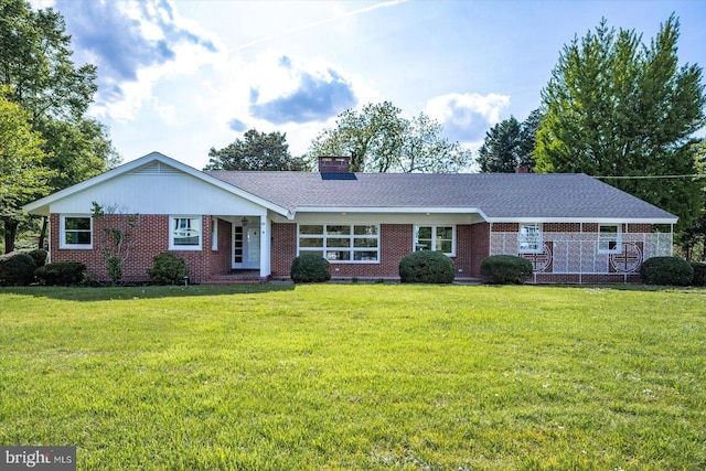 210 N Main St, Berlin, MD 21811 - ranch-style house featuring a chimney, a front yard, and brick siding