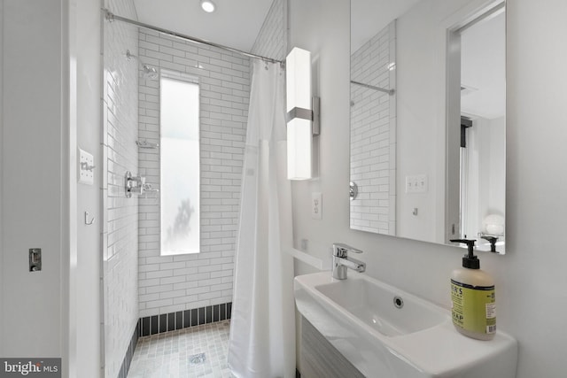 bathroom with recessed lighting, a sink, and a shower stall