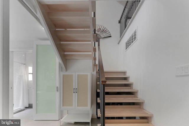 stairway featuring visible vents