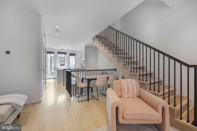 staircase with recessed lighting, baseboards, and wood finished floors