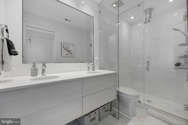 full bath with a sink, a shower stall, double vanity, and visible vents