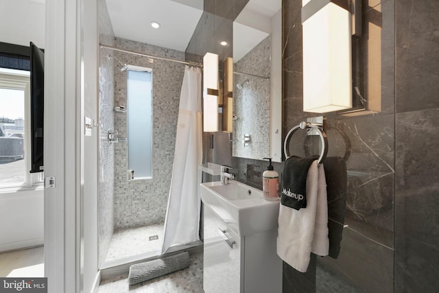 full bathroom with plenty of natural light, decorative backsplash, and a shower stall