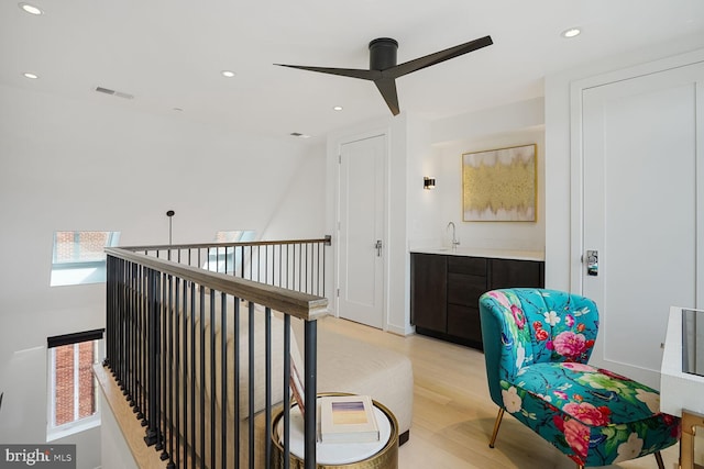 interior space with recessed lighting, visible vents, a sink, and light wood finished floors