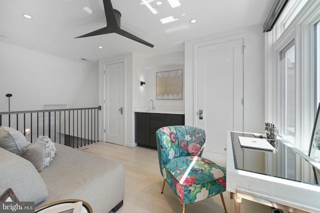 living room featuring recessed lighting, a ceiling fan, and light wood finished floors
