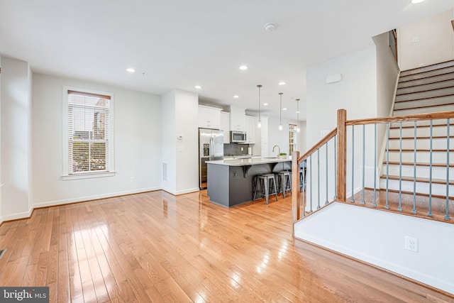 11350 Ridgeline Rd, Fairfax, VA 22030 - unfurnished living room featuring recessed lighting, light wood-style floors, baseboards, and stairs