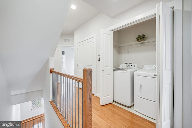 11350 Ridgeline Rd, Fairfax, VA 22030 - clothes washing area with recessed lighting, laundry area, visible vents, independent washer and dryer, and light wood-type flooring