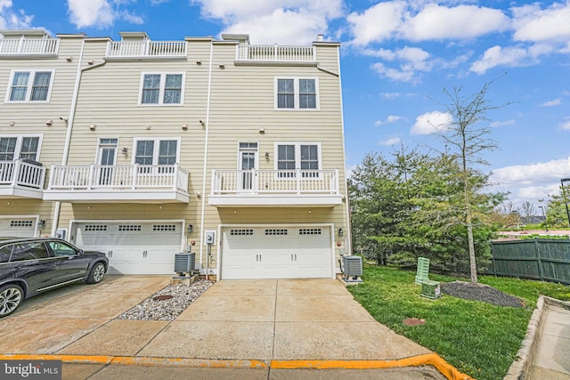 11350 Ridgeline Rd, Fairfax, VA 22030 - back of house with central air condition unit, an attached garage, fence, and concrete driveway