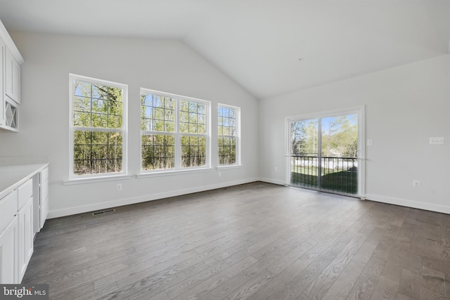 8504 Wendy St, Clinton, MD 20735 - unfurnished living room featuring plenty of natural light, dark wood-style floors, lofted ceiling, and baseboards