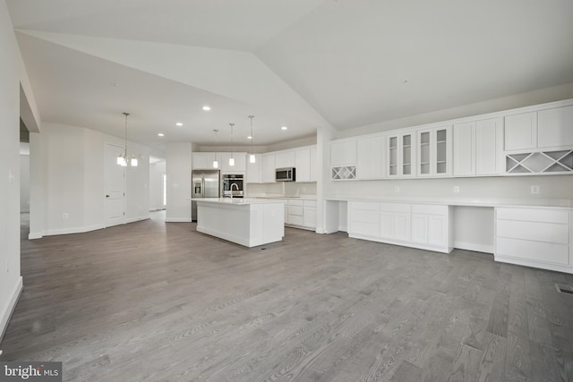 8504 Wendy St, Clinton, MD 20735 - kitchen with appliances with stainless steel finishes, recessed lighting, lofted ceiling, a center island with sink, and white cabinets