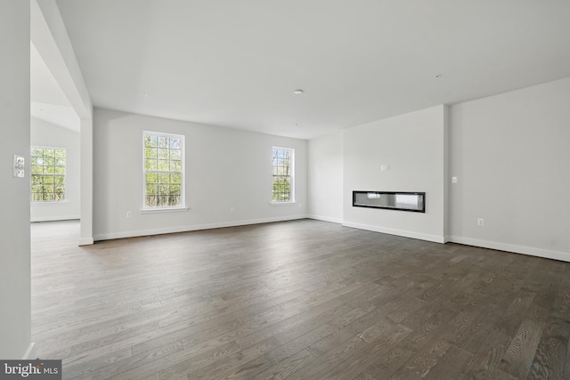 8504 Wendy St, Clinton, MD 20735 - unfurnished living room featuring healthy amount of natural light, dark wood-style floors, and baseboards