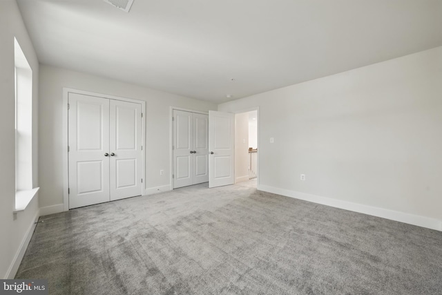 8504 Wendy St, Clinton, MD 20735 - unfurnished bedroom with multiple closets, baseboards, and carpet floors