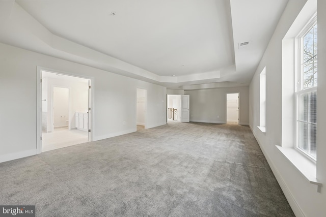 8504 Wendy St, Clinton, MD 20735 - unfurnished living room featuring a raised ceiling, carpet flooring, and baseboards