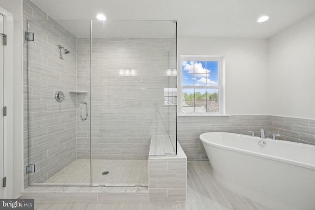 8504 Wendy St, Clinton, MD 20735 - full bath with a freestanding tub, tile patterned flooring, tile walls, a shower stall, and recessed lighting