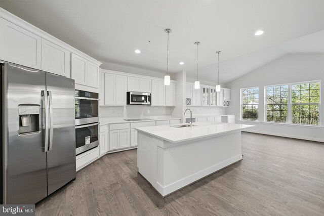 8504 Wendy St, Clinton, MD 20735 - kitchen with stainless steel appliances, a sink, dark wood-type flooring, a center island with sink, and white cabinets