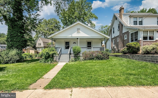 603 Hillcrest Ave, Wilmington, DE 19809 - bungalow-style home with a chimney, a porch, a front yard, and brick siding