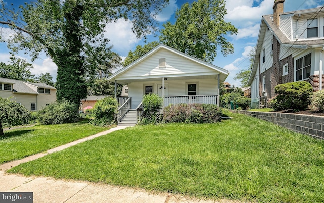 603 Hillcrest Ave, Wilmington, DE 19809 - bungalow featuring covered porch, a front yard, and a chimney