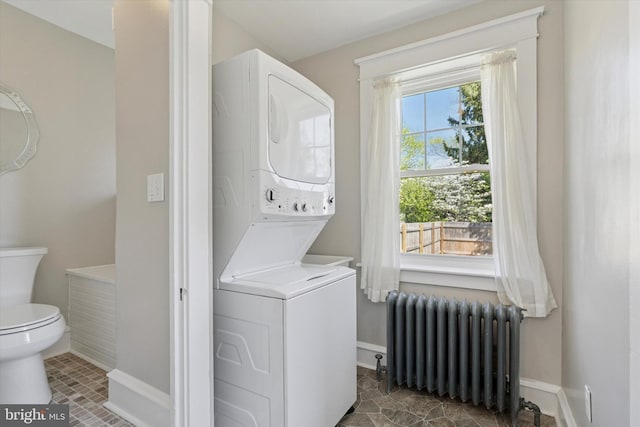 33 S Brighton Ave, Upper Darby, PA 19082 - clothes washing area with laundry area, baseboards, radiator, and stacked washer / drying machine