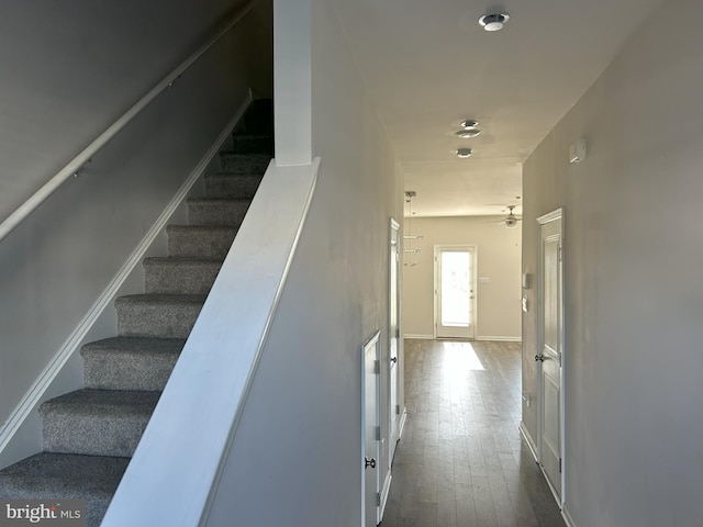 stairs with hardwood / wood-style floors and baseboards