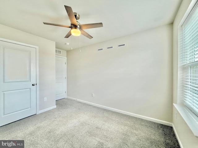 unfurnished bedroom with visible vents, baseboards, and carpet