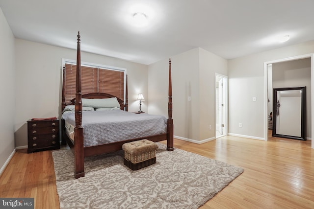 bedroom with baseboards and light wood finished floors