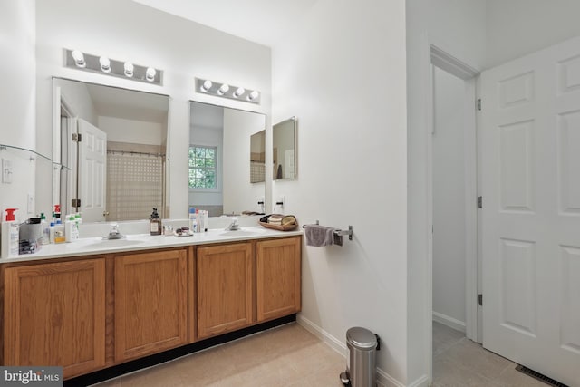 full bath with a sink, tile patterned floors, and visible vents