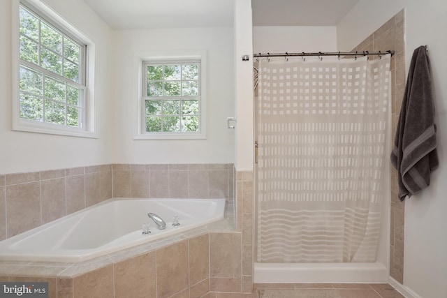 full bath featuring a bath, a stall shower, and tile patterned floors