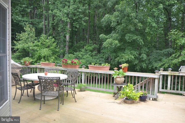 wooden terrace with outdoor dining area