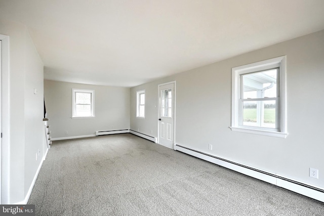 unfurnished living room featuring carpet, a baseboard radiator, and baseboards