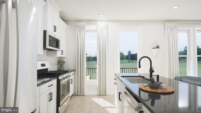 43290 Farringdon Sq, Broadlands, VA 20148 - kitchen featuring stainless steel appliances, a sink, dark countertops, healthy amount of natural light, and recessed lighting