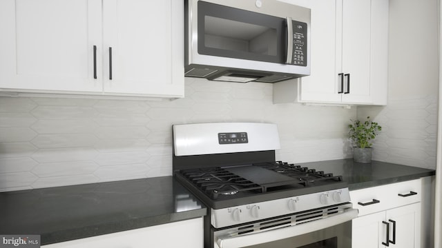 43290 Farringdon Sq, Broadlands, VA 20148 - kitchen featuring stainless steel microwave, range with gas cooktop, dark countertops, and white cabinetry