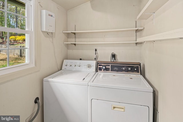 washroom with independent washer and dryer and laundry area
