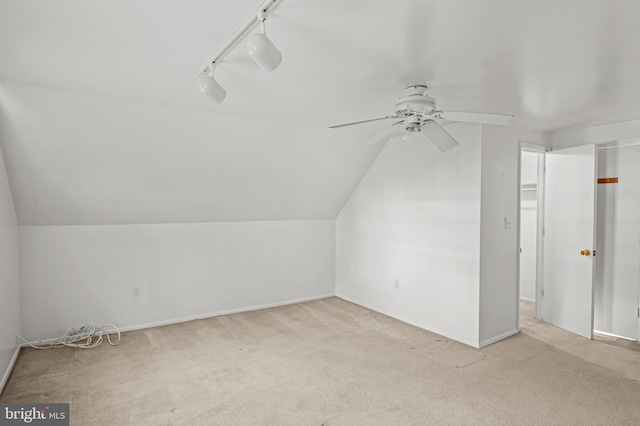 bonus room with carpet, baseboards, lofted ceiling, and ceiling fan