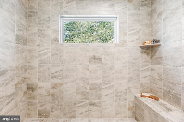 bathroom with a tile shower