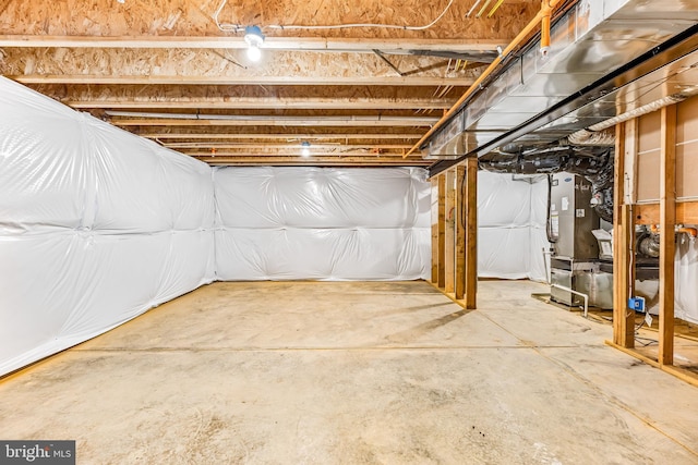 unfinished basement featuring heating unit
