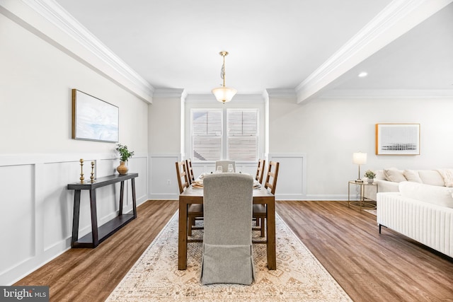 dining room with crown molding, wood finished floors, wainscoting, and recessed lighting