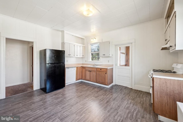 kitchen featuring light countertops, dark wood-style flooring, a sink, and white appliances